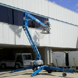 Lift rental- Genie 50 foot trailer mounted articulated lift cleaning windows at Port Columbus International Airport - Columbus, Ohio